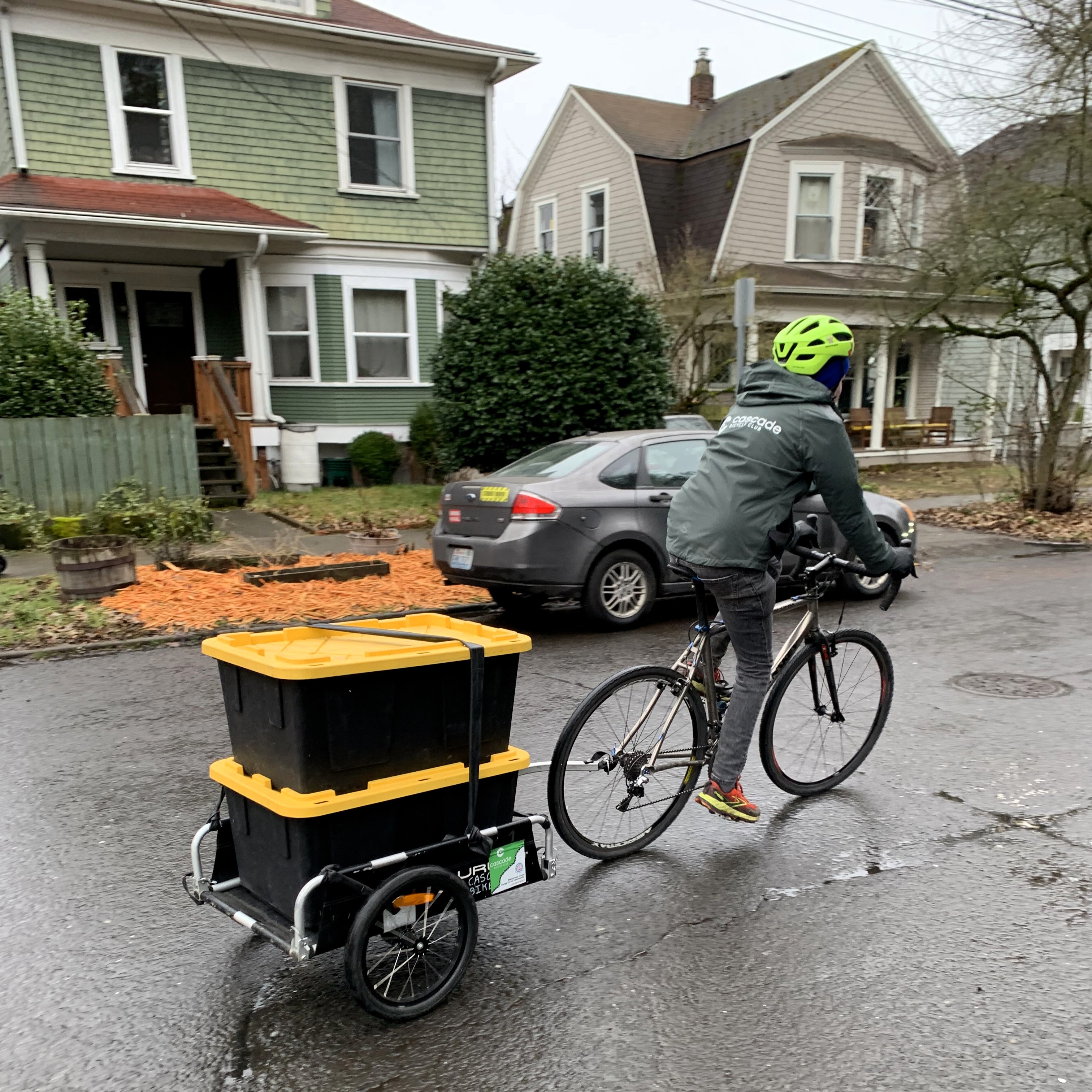 a Pedaling Relief Rider pulls two bins of rescued food 